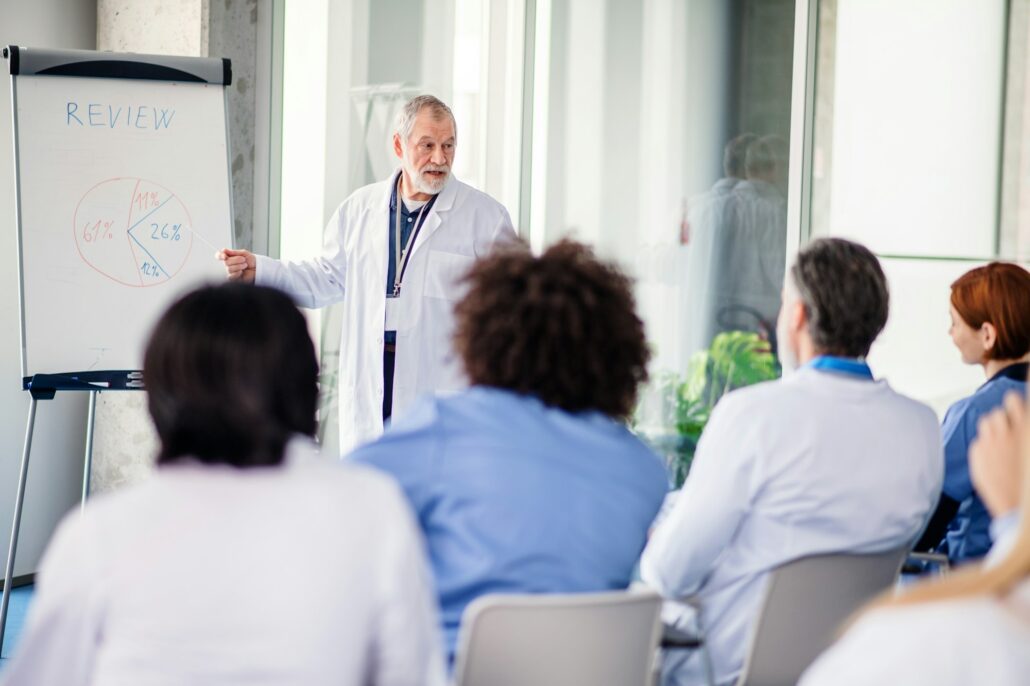 Group of doctors listening to presentation on medical conference.