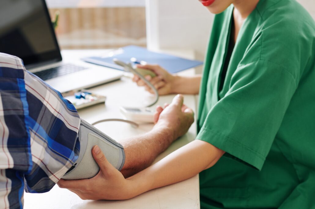 Nurse measuring blood pressure of patient