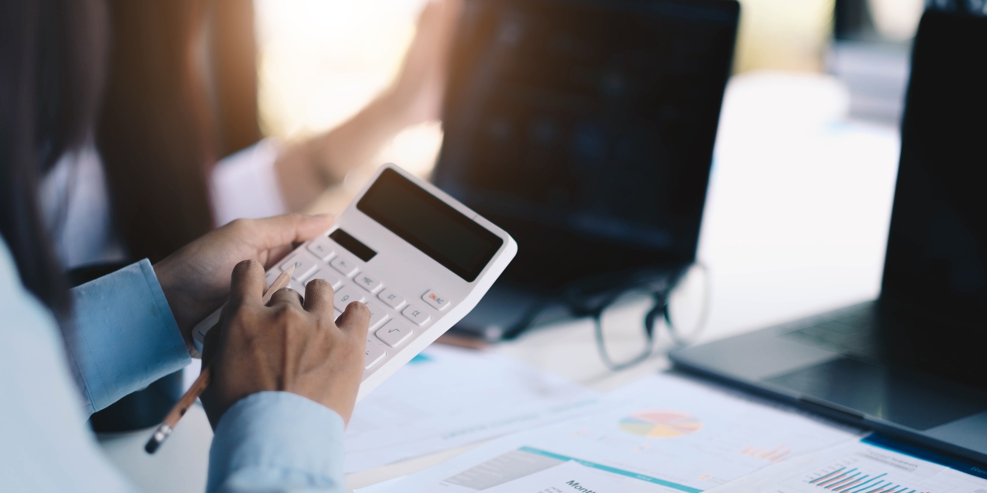 Group businessman hand using calculator Calculating bonus to employees to increase productivity