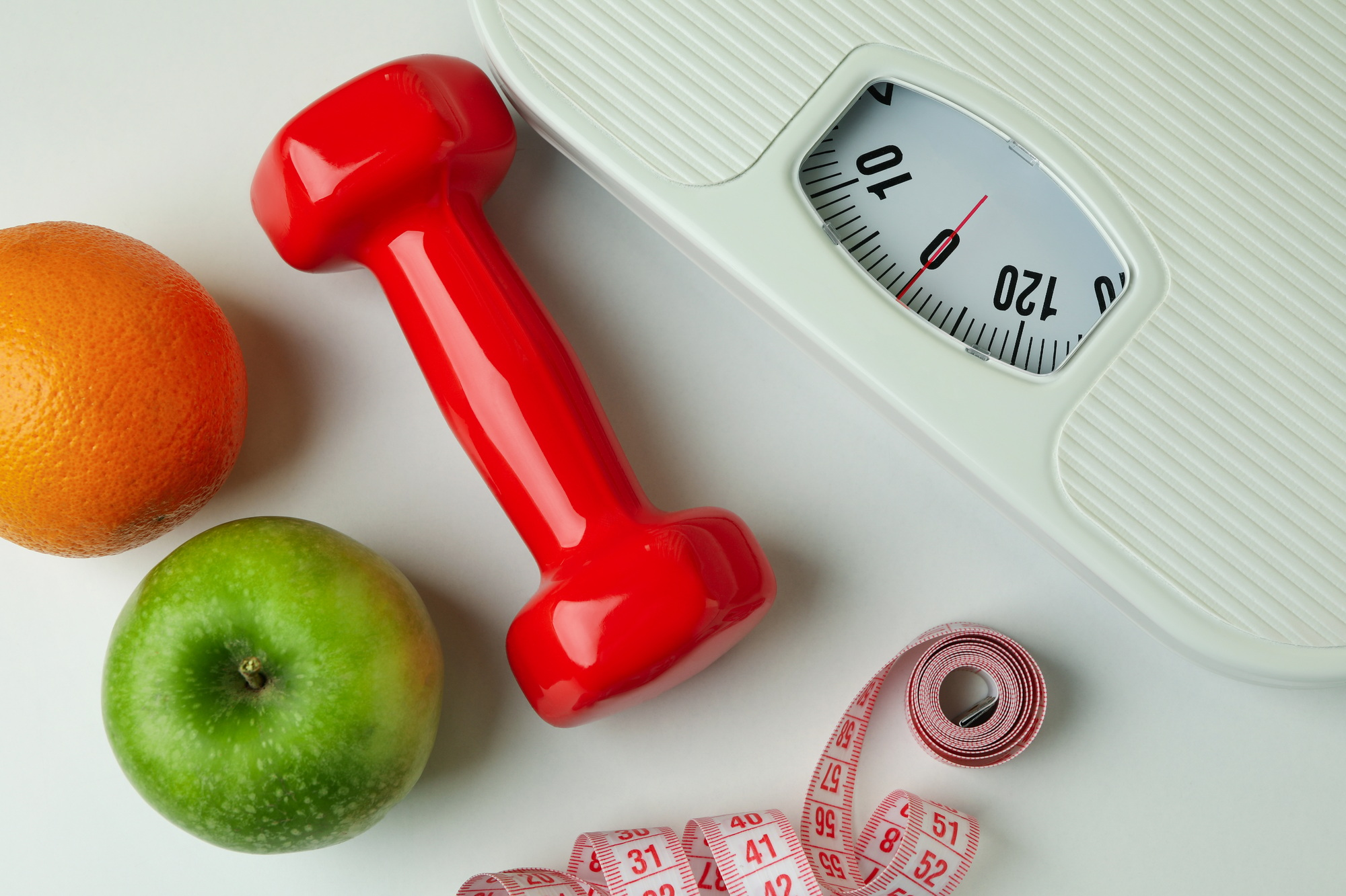 Weight loss accessories on white background, close up