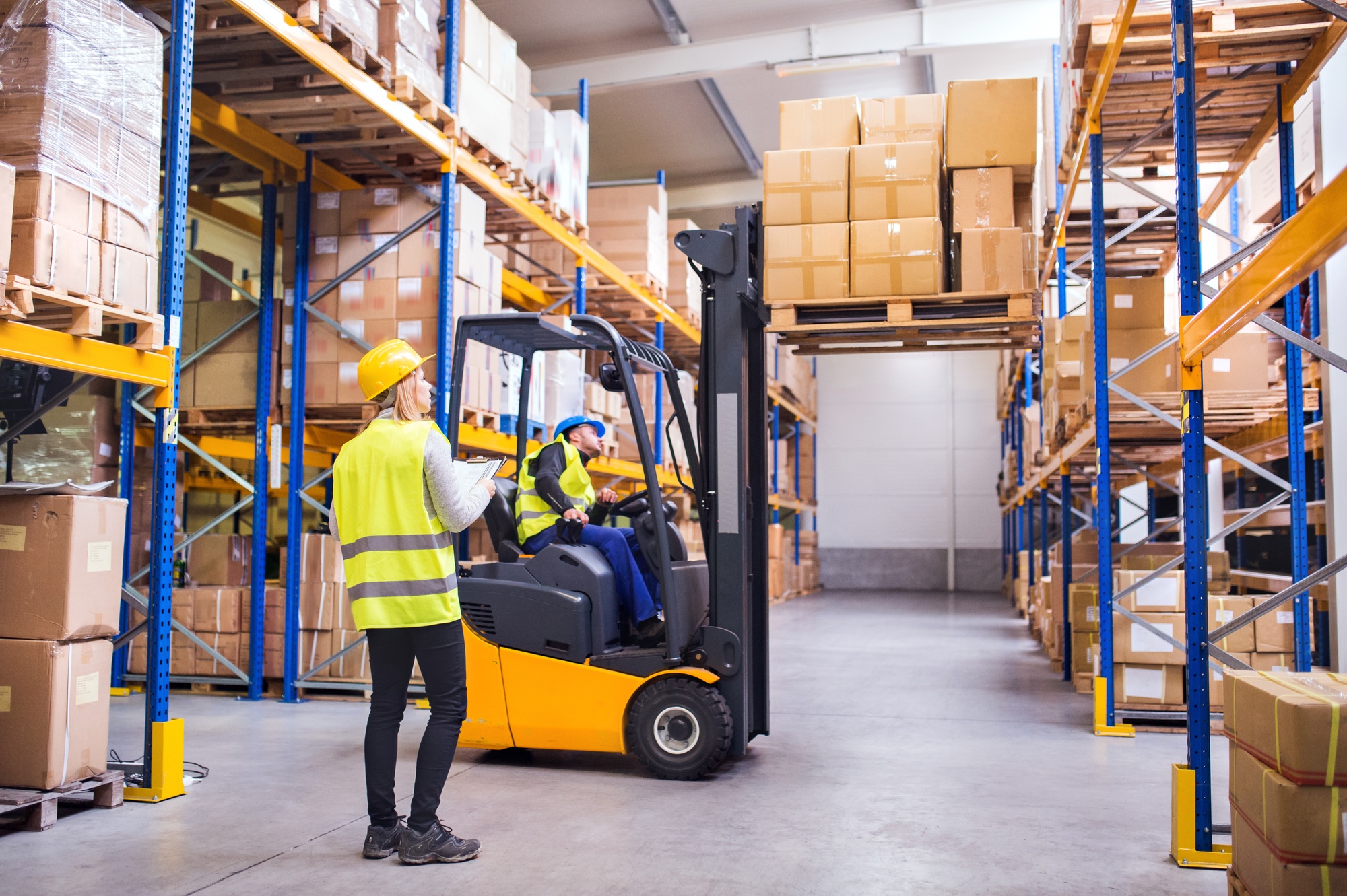 Young warehouse workers working together.