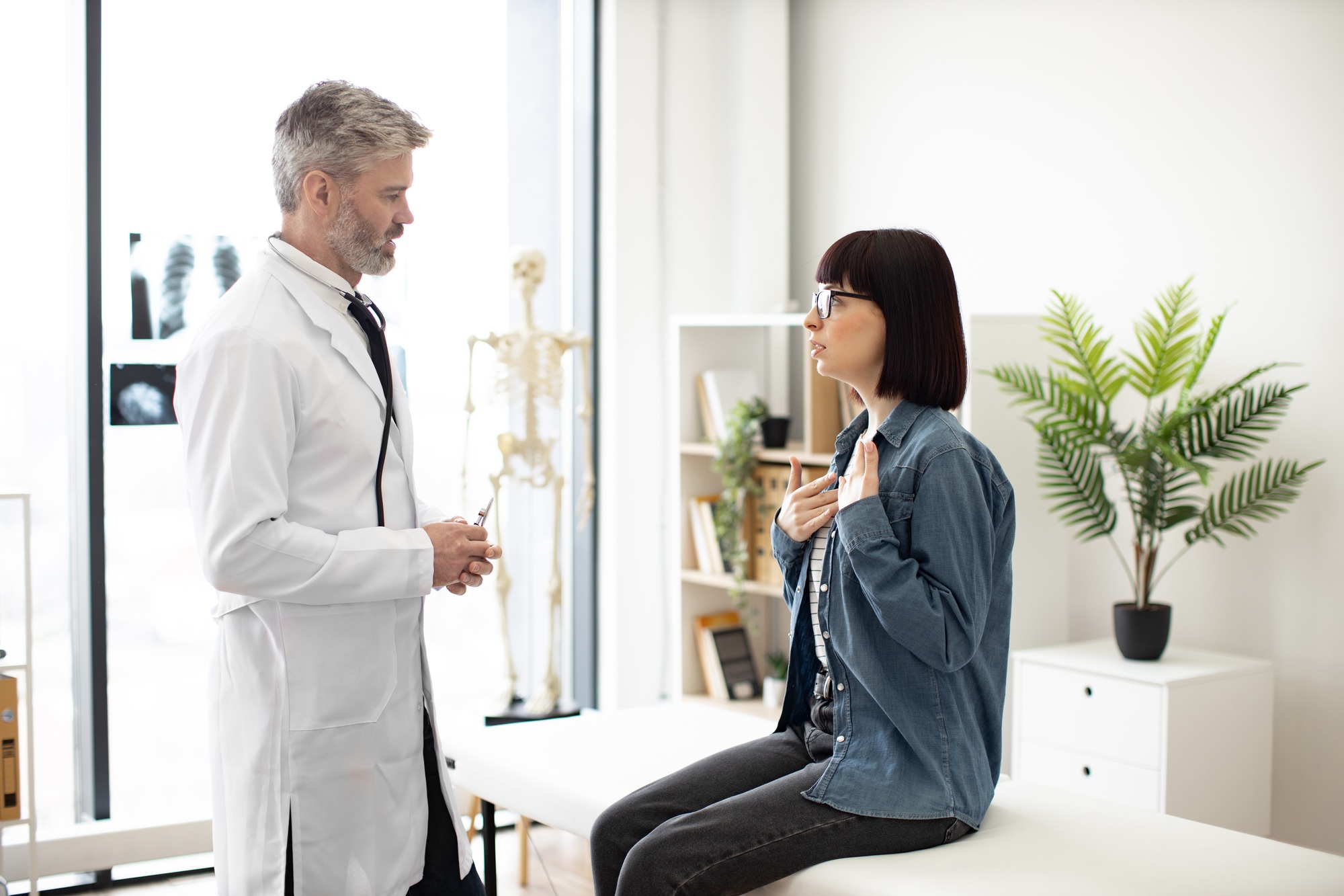 Lady visiting male family doctor at private practice