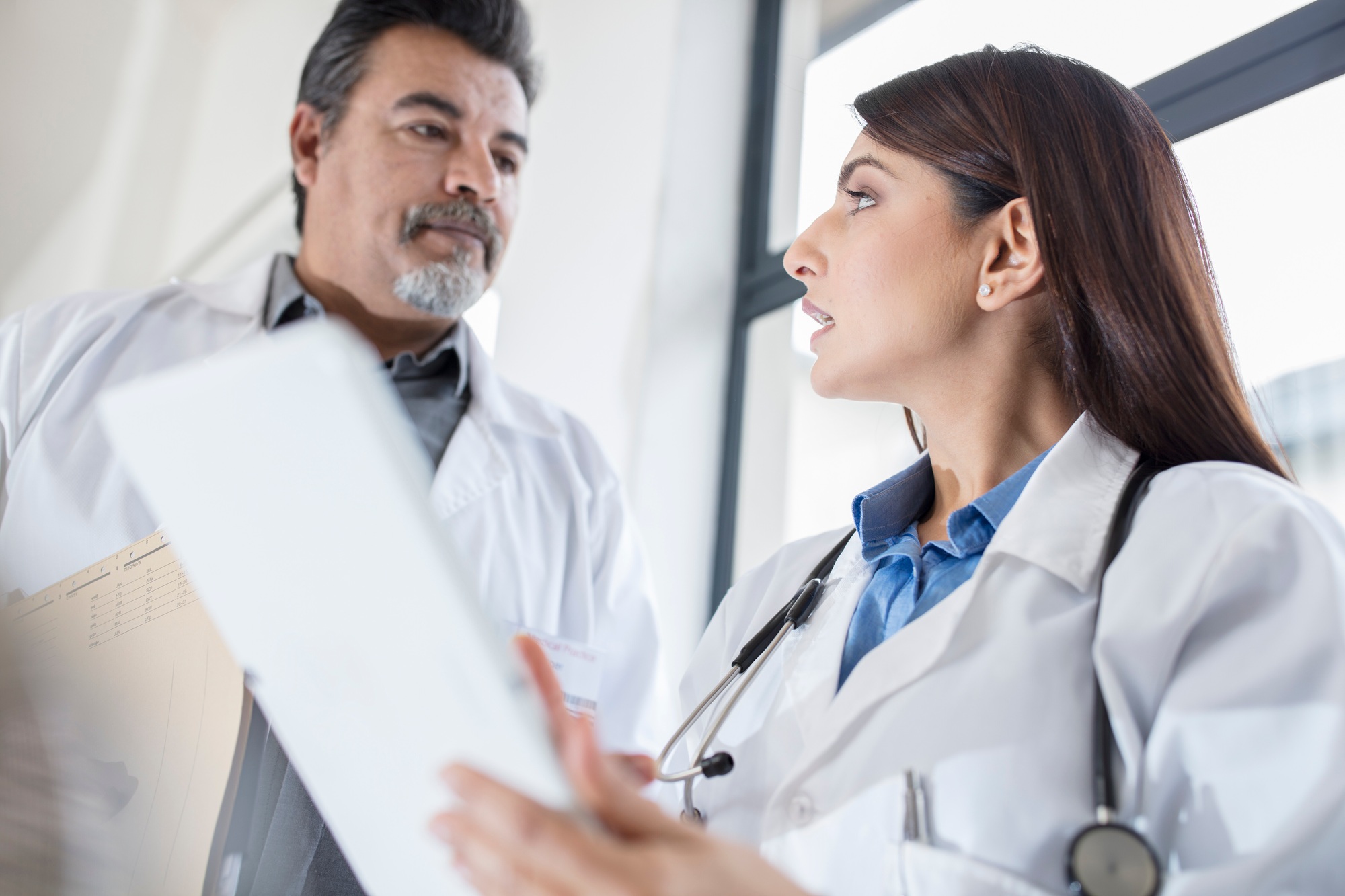 Doctors discussing patient records